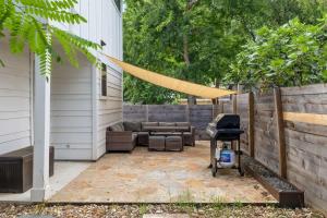 a backyard patio with a hammock and a grill at East Side Haven - Blocks from Local Food Legends in Austin