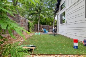 a yard with a chair next to a house at East Side Haven - Blocks from Local Food Legends in Austin