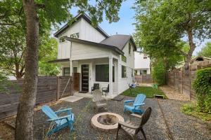 a backyard with chairs and a fire pit in front of a house at East Side Haven - Blocks from Local Food Legends in Austin +22 photos