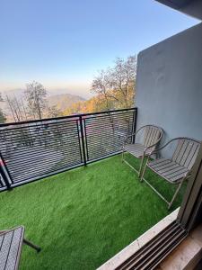 a balcony with chairs and a view of the mountains at Hotel SecondHome in Murree