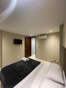 Ένα ή περισσότερα κρεβάτια σε δωμάτιο στο Apto Grand- Ithiel