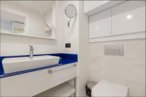 Un baño blanco con lavabo e inodoro. en Panorama Cental Hotel Batumi, en Batumi 101 fotos más