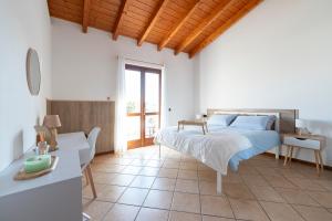 a bedroom with a bed and a table and a desk at Green Hill apartment in Salò