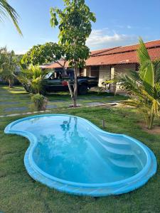 una piscina azul en el patio de una casa en Pousada Vila Caburé, en Luís Correia