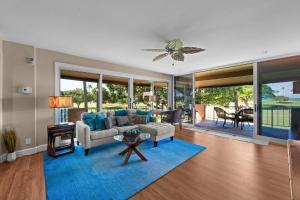 a living room with a couch and a blue rug at Maui Eldorado H202 in Kaanapali