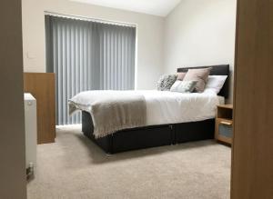 a bedroom with a bed and a large window at Cosy 4 Bed House In Solihull Near Town-NEC-BHX in Sheldon