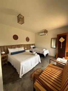Ένα ή περισσότερα κρεβάτια σε δωμάτιο στο Vila Orun Pousada