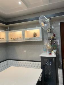 a kitchen with a fan on the wall at عمارة زكي الرمحي 6 in Amman