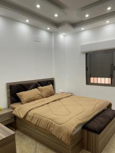 a bedroom with a large bed with a window at عمارة زكي الرمحي 6 in Amman