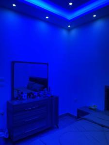 a blue room with a dresser with a mirror at عمارة زكي الرمحي 6 in Amman
