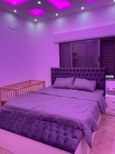 a purple bedroom with a large bed with purple lighting at عمارة زكي الرمحي 6 in Amman +39 photos