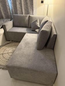 a grey couch in a living room with a coffee table at استديو بجلسة بمطبخ مستقل دخول ذاتي 13 in Buraydah