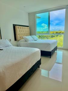 Postel nebo postele na pokoji v ubytování Karibmed Cartagena