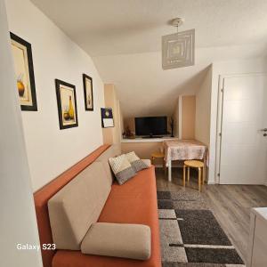 a living room with a couch and a table at Ljudina in Kupres
