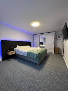 a bedroom with a large bed and a mirror at House in the Heart of Râșnov Old Town in Râşnov