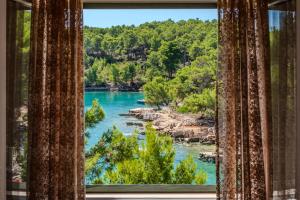 a view of a river from a window at Luxury Villa Kate - in Lucice Bay with turquoise sea, Amazing Seaviews, and Heated Pool in Milna
