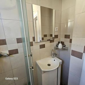 a bathroom with a sink and a mirror at Ljudina in Kupres +5 photos