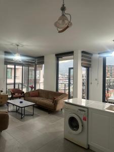 a living room with a couch and a washing machine at Moonlight Home in Nicosia