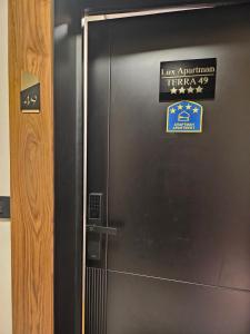 a metal elevator with a sign on the door at Zlatibor Lux Apartman - Terra 49 in Zlatibor