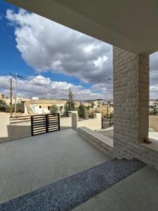 a large patio with a view of a desert at Jeeso hotel in Jerash