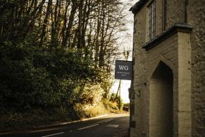 a brick building with a sign on the side of a road at Winyard's Gap Inn in South Perrott