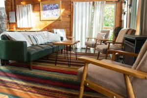 a living room with a couch and chairs at The Cliffside Cabin - Stunning Views in Red River Gorge in Rogers