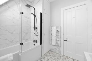 a bathroom with a shower and a glass door at Lochside Apt, D in Angus