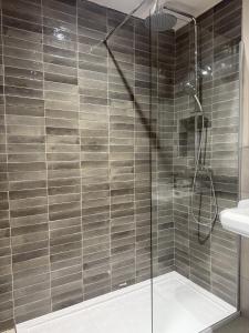a shower with a glass door in a bathroom at The Lord Raglan in Staplehurst