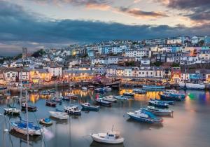 a group of boats in a harbor with a city at Fairy Cove Cottage in Paignton