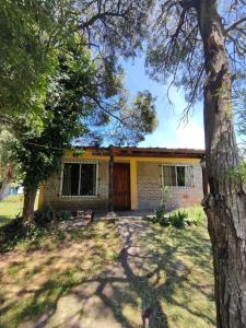 a house with a tree in front of it at La Posada del Mar in Miramar +36 photos