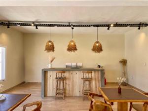 a room with a bar with chairs and tables at Altos del Peñón in El Peñón