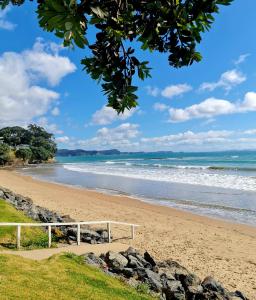 ein Strand mit einer weißen Bank im Sand in der Unterkunft Kiwi Classic in Red Beach