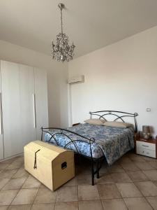 a bedroom with a bed with a box on the floor at Rosignano Marittimo Rosa Bianca in Rosignano Marittimo