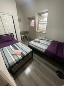 a bedroom with two beds and a table in it at Central Downtown New Year Stay- Self Checkin & Free Wifi in Toronto