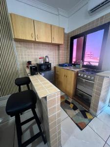 a kitchen with a counter and a stove top oven at Wharf 303 in Pointe-Noire +1 photo