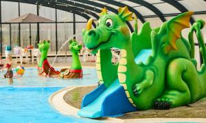 a water park with a pool with a dragon slide at Husodde Strand Camping & Cottages in Horsens
