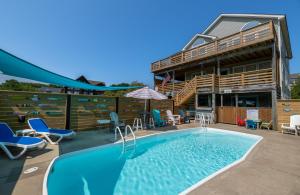 a swimming pool in front of a house at D3943 The Pup Deck - Oceanside, Pool, Hot Tub, Pets OK, Beach & Sound Access! in North Point