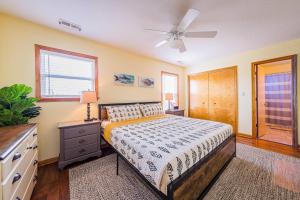 a bedroom with a bed and a ceiling fan at D3943 The Pup Deck - Oceanside, Pool, Hot Tub, Pets OK, Beach & Sound Access! in North Point +77 photos
