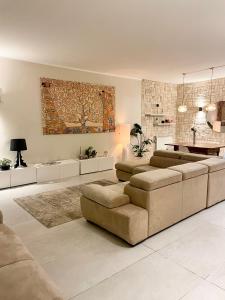 a living room with two couches and a table at Casa Della Baia With a beautiful view in Varazze