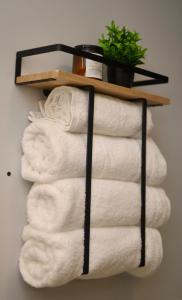 a stack of towels on a shelf in a bathroom at Modern Lakeview Escape | Scenic Deck • Fire Pit in Monroe