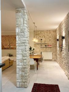 a kitchen and dining room with a stone wall at Casa Della Baia With a beautiful view in Varazze