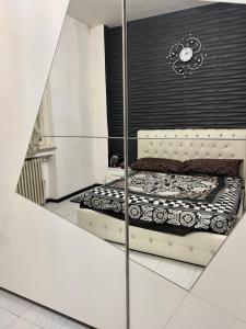 a bedroom with a bed in a mirror at private room in Seveso