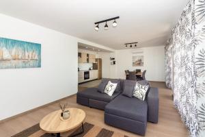 a living room with a couch and a table at Apartmani Ljubica in Duće