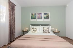 a bedroom with a large bed with two side tables at Apartmani Ljubica in Duće