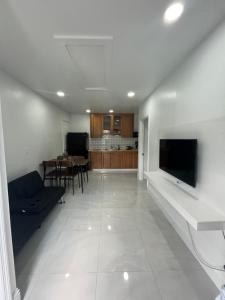 a living room with a couch and a tv on a wall at Perfect go away in Fort Myers