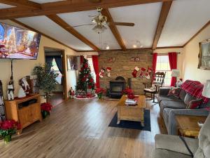 a living room with a christmas tree and a couch at 15 miles to Windham Mountain ! King Bed, Game Room, Out Door Patio in Cairo