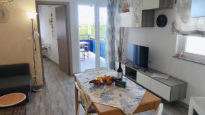 a small living room with a table and a television at Apartamento Rosamar, sea view in Los Cristianos