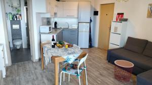 a kitchen and a living room with a table and a couch at Apartamento Rosamar, sea view in Los Cristianos