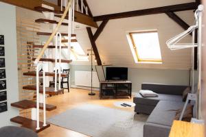 a living room with a couch and a staircase at Bremen-Weyhe - peaceful - kitchen - wifi in Weyhe