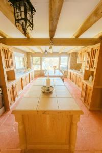 a large kitchen with a wooden table in a room at Beachfront house for 20 people in Vichuquén Lake